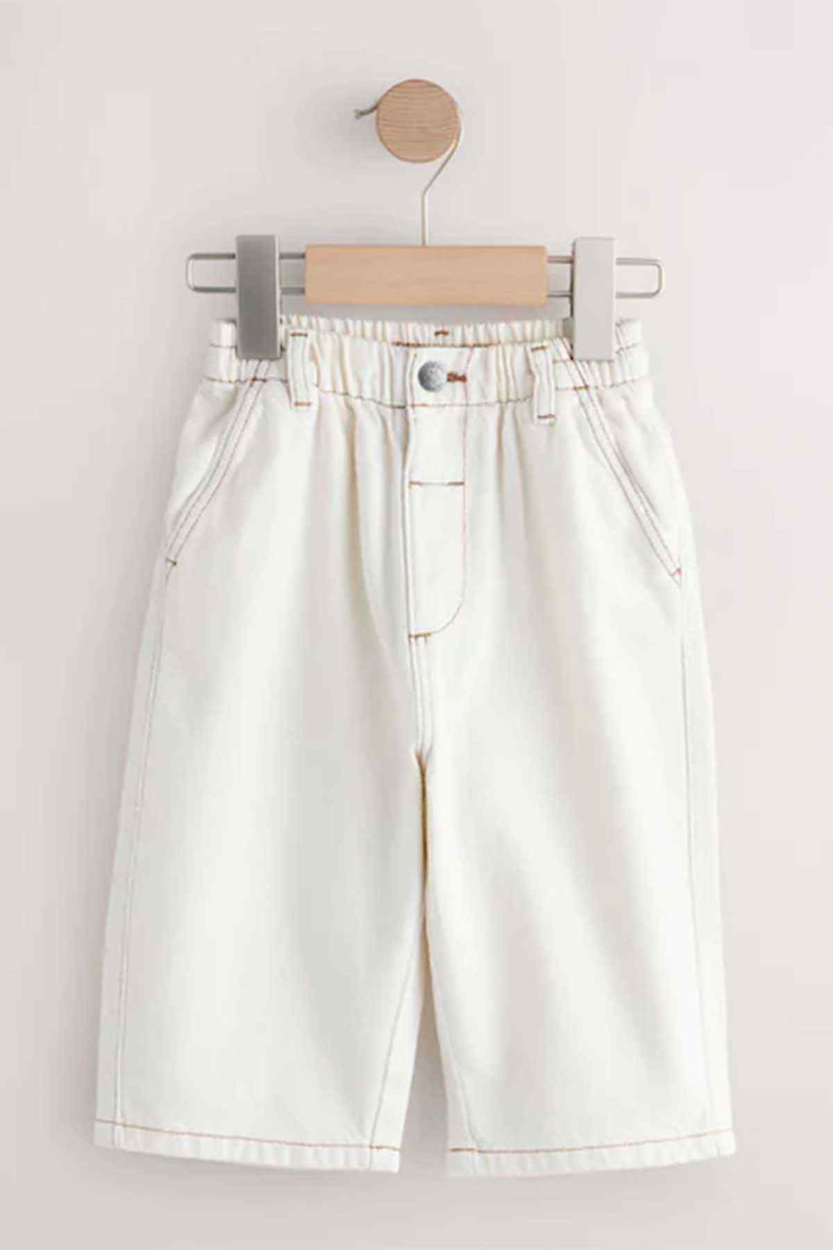 Ecru kids pants with elastic waistband, front fly and side seam pockets