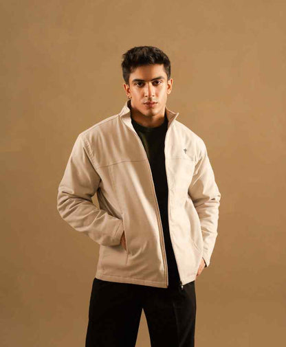 Beige zip-up jacket with stand collar and chest logo, front view, fitted