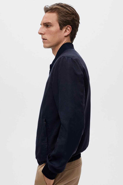 MANGO navy bomber jacket side profile with zip-front and ribbed hem