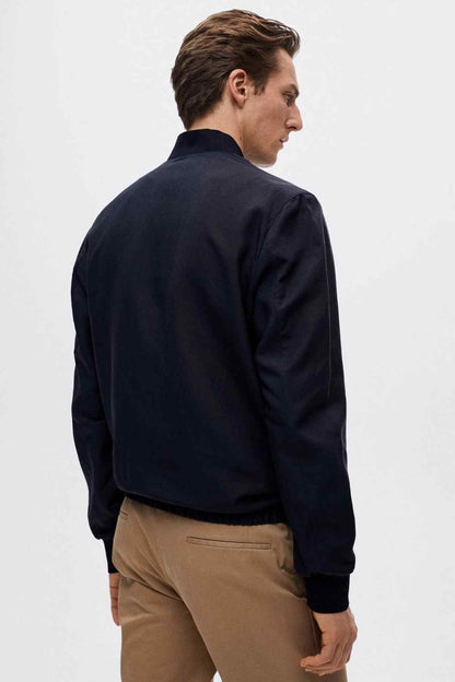 MANGO navy bomber jacket side view with zip-front and ribbed cuffs
