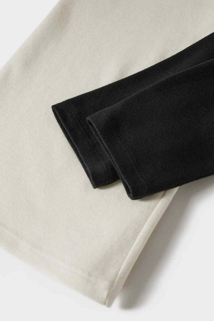 Ecru T-shirt with black contrast sleeve cuff and folded hem detail