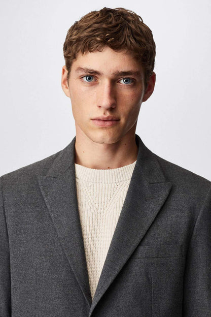 Grey suit jacket close-up, notch lapel and button front