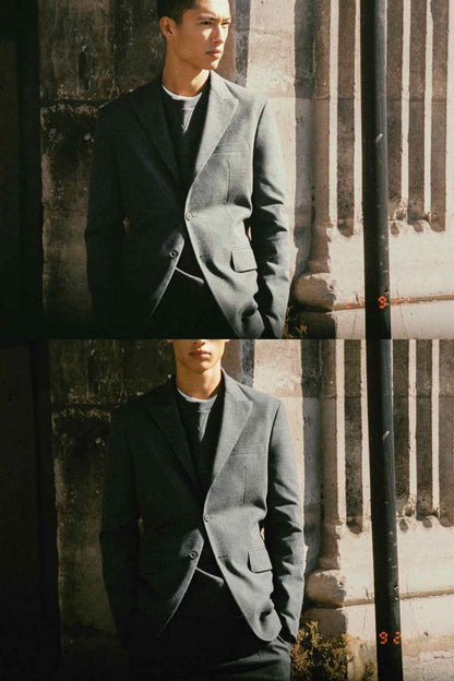 Grey suit jacket on model, button fastening and tailored silhouette