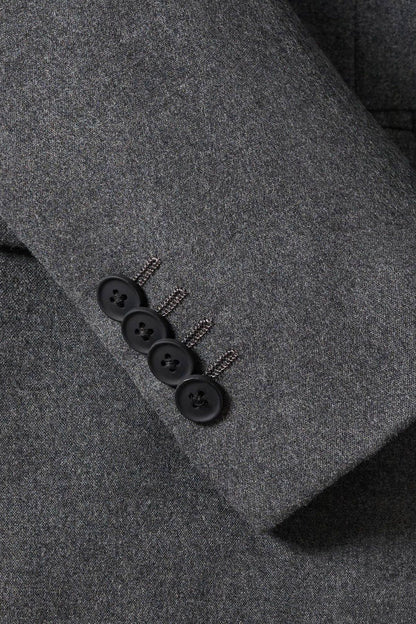 Grey suit jacket detail, dark buttons on the front placket