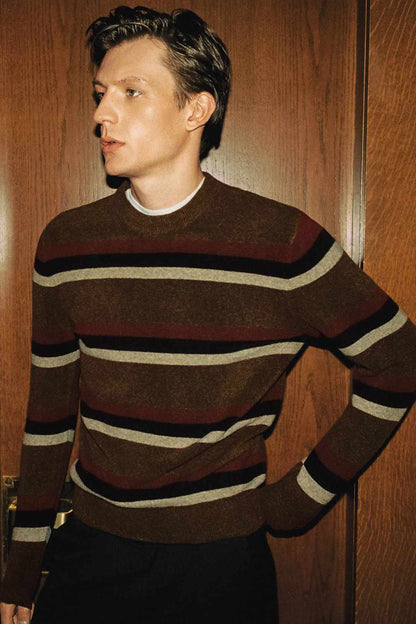 Brown striped knit sweater with crew neck and long sleeves, angled view