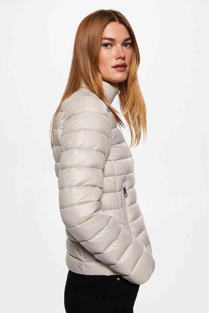 Light pastel grey quilted puffer jacket, side view, full zipper and sleeve pocket