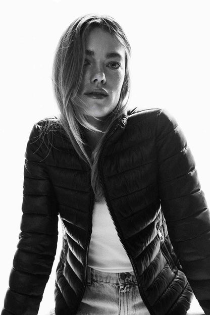 Black quilted puffer jacket with front zip and high collar