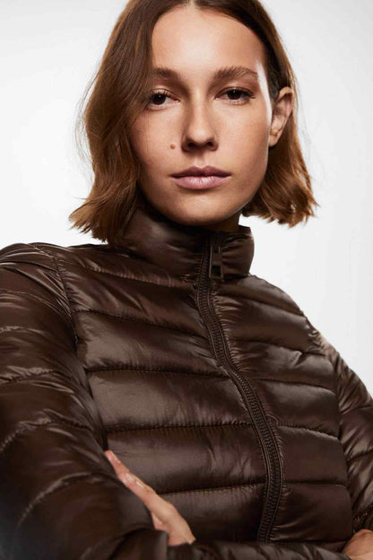 Brown quilted puffer jacket close-up with stand collar and zipper placket