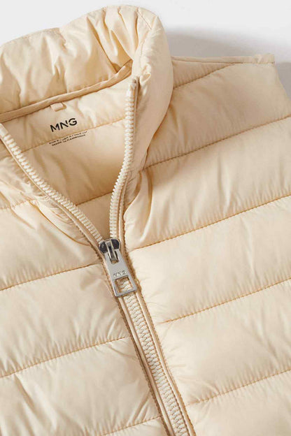 Ecru quilted puffer vest zip close-up with MNG tag and metal slider