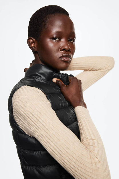 Black quilted puffer vest with high collar and front zipper detail