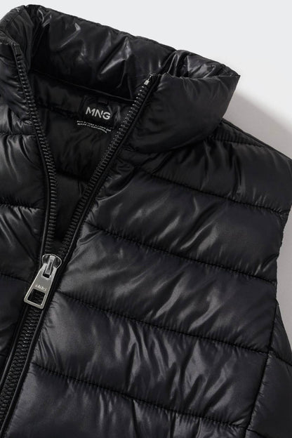 Black quilted vest close-up with front zipper and MNG logo patch