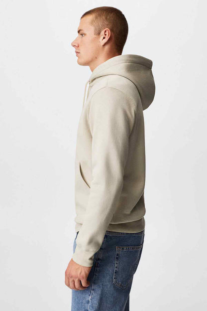 Ecru pullover hoodie side view with drawstring hood and ribbed cuffs
