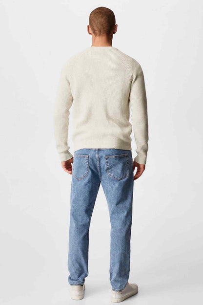 Ecru ribbed knit crewneck sweater with long sleeves, back view on model