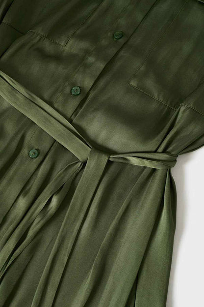 Olive-green shirt dress fabric detail with button placket and tied waist