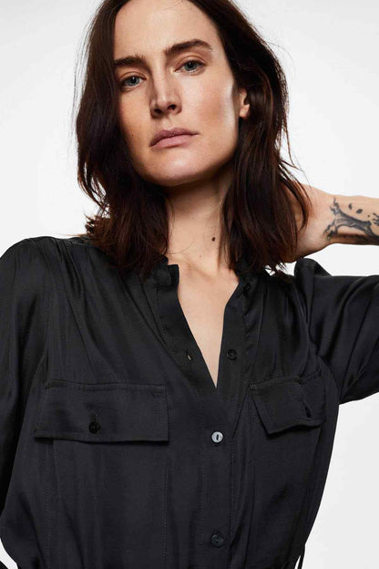 Black shirt dress close-up: V neckline with buttons and chest flap pocket