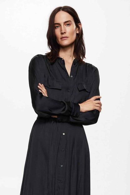 Black shirt dress with button front, flap pockets, and tied waist, long sleeves