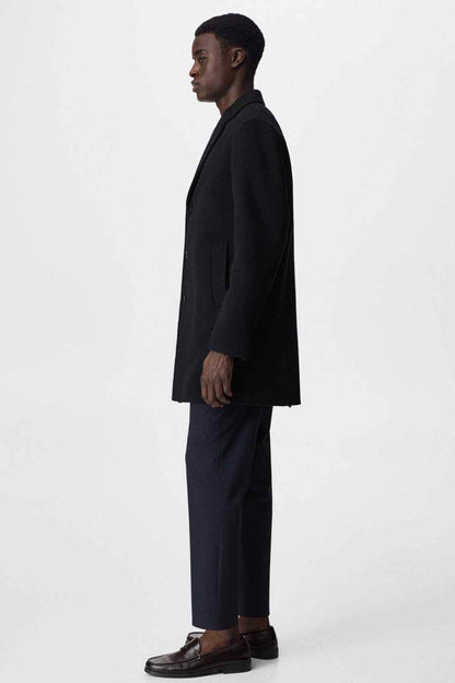 MANGO navy overcoat side view with long sleeves and button placket