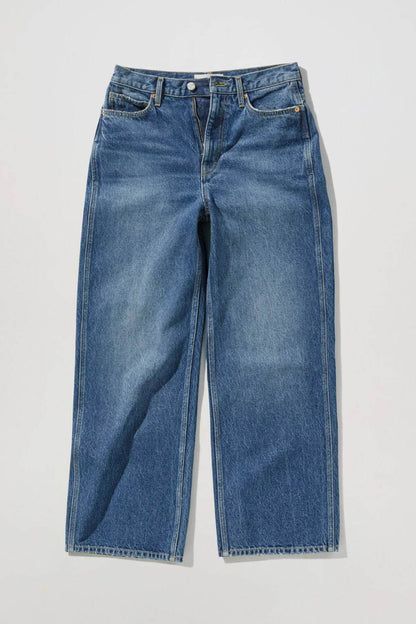 MANGO dark blue denim jeans laid flat, wide-leg with button fly and pockets