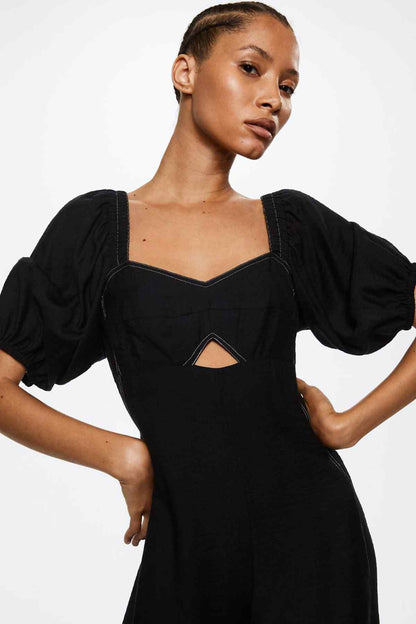 Black sweetheart-neck jumpsuit with puff sleeves and seam detail at front