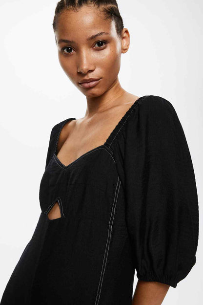 Black square-neck jumpsuit with puff sleeve and smocked bodice