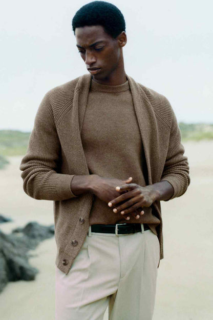 Beige knit cardigan with V-neck and button-front, worn outdoors