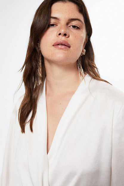 Off-white draped V-neck blouse with long sleeves, neckline close-up