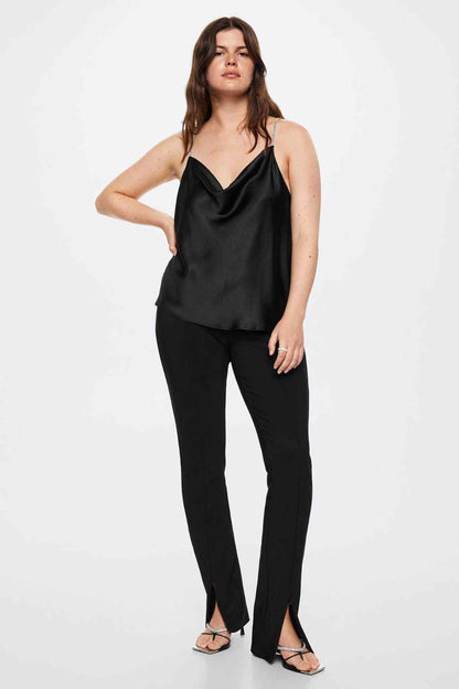 Black satin camisole top with thin chain straps and black jeans