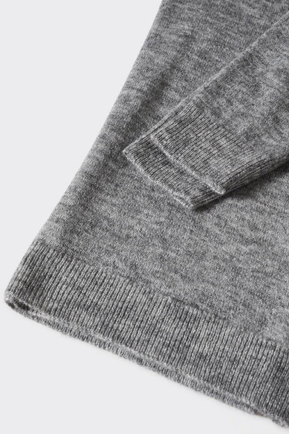 Heather grey knit sweater ribbed hem and textured knit detail close-up
