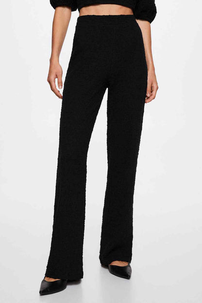Black high-waist wide-leg trousers with relaxed straight-to-flare legs