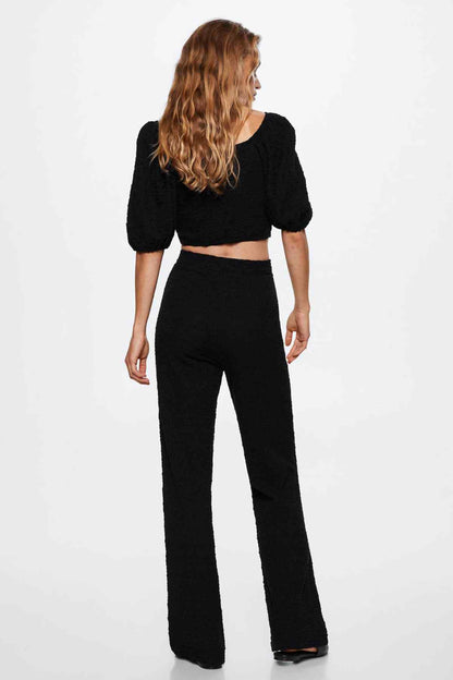 Black high-waist wide-leg trousers, back view with relaxed drape
