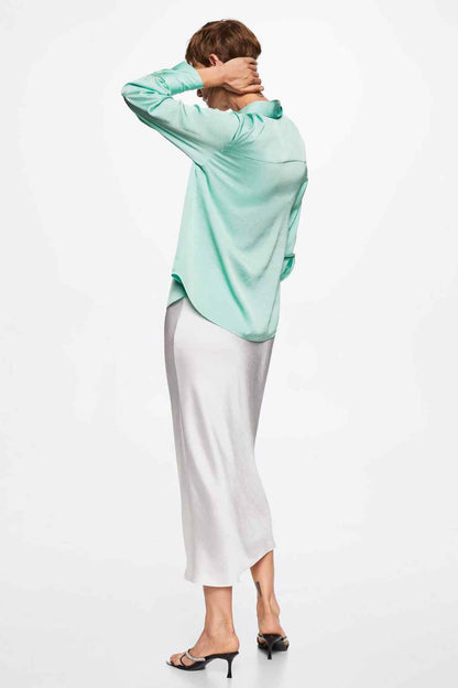 Pastel green button-up shirt with pointed collar and long sleeves, side view