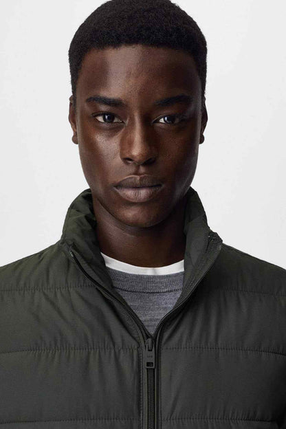 Mango dark olive puffer jacket close-up with stand collar and zipper front.