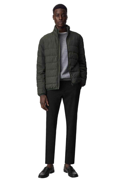 Mango dark olive quilted puffer jacket on model, full zipper and side pockets.
