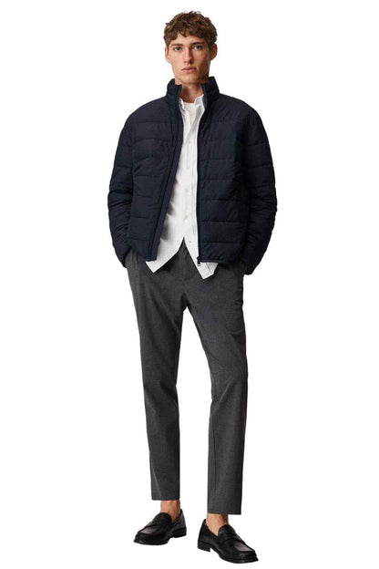 MANGO men's navy quilted puffer jacket worn with dark trousers