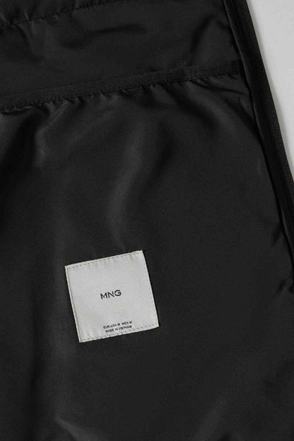 MNG label on black puffer jacket lining interior