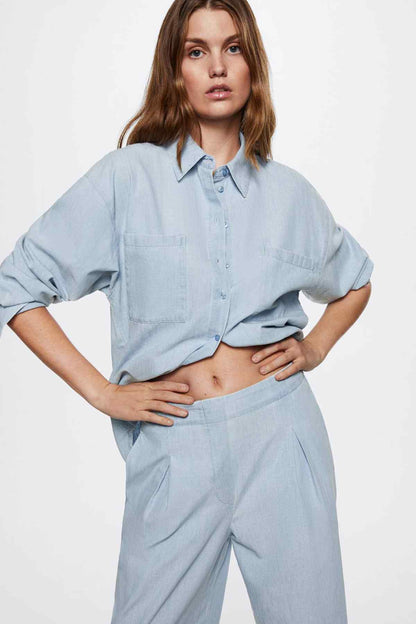 Light blue denim wide-leg pants with pleated front and side pockets