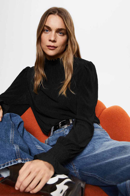 Black high-neck blouse with smocked collar and long sleeves