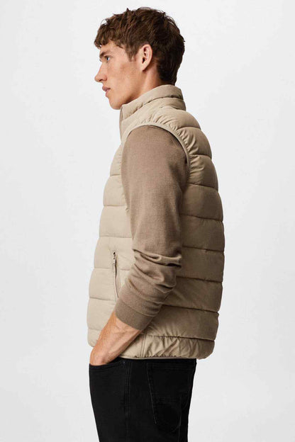 Ice grey puffer vest on-model from side, quilted panels