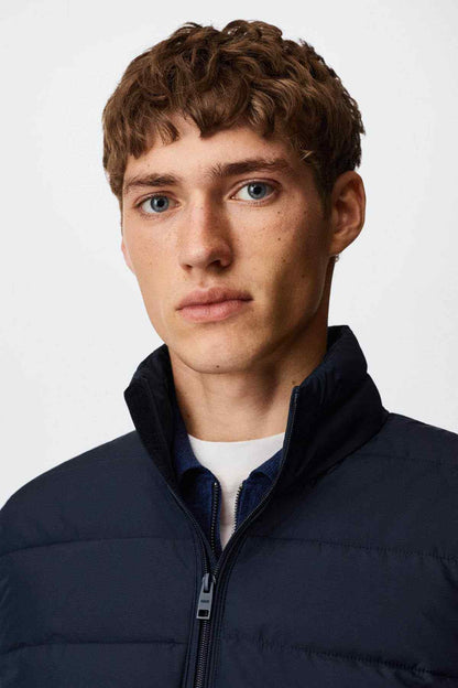 MANGO navy quilted puffer vest close-up of stand collar and full-zip zipper