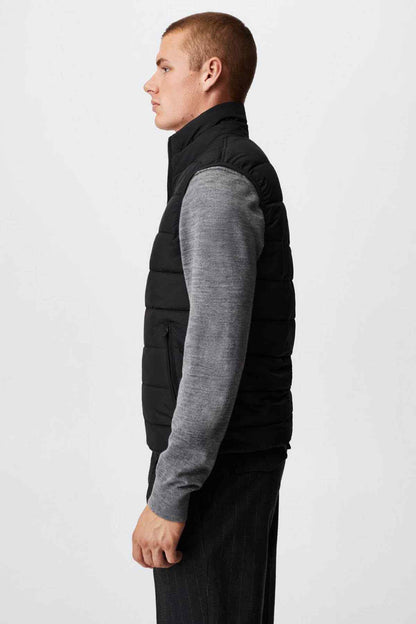 Black padded gilet vest side view with quilted panels and front zip
