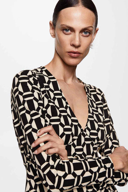 Black and cream geometric print mini dress with deep V-neck and long sleeves