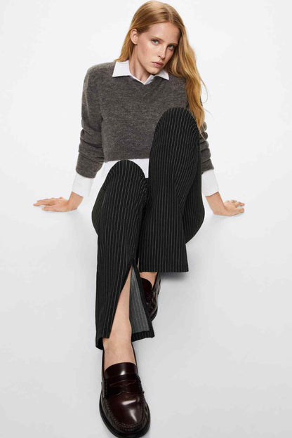 Black pinstripe trousers with side slit at hem