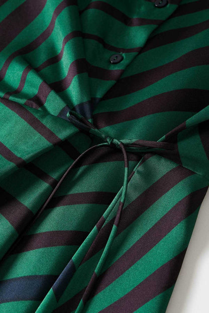 Close-up of green and dark striped midi dress fabric with tied waist