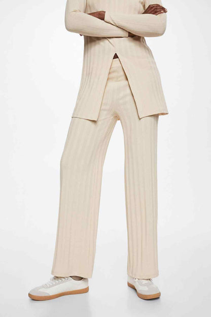 Beige long-sleeve tunic with front slit and striped wide-leg pants, full-body view