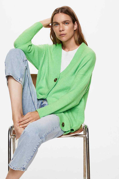 Green knit V-neck cardigan with dark button placket and patch pockets