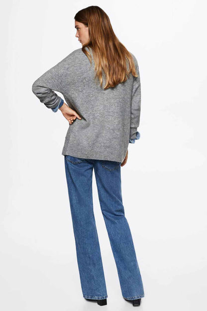 Grey knit cardigan draped open, long sleeves, worn with blue jeans