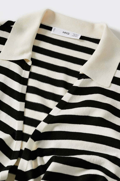 Close-up of black-and-white striped knit V-neck top with cream collar