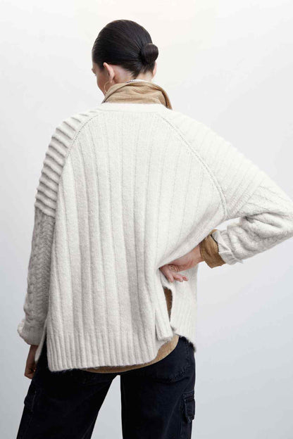 Ecru cable-knit cardigan, back view with ribbed knit texture and button placket