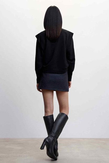 Black crewneck mini dress, rear view, long sleeves and short hem