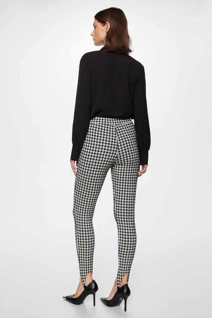 Black-and-white houndstooth trousers, back view with cuffed hem